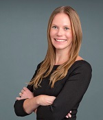 Headshot style photo of Dr. Paige Cervantes in front of a grey background